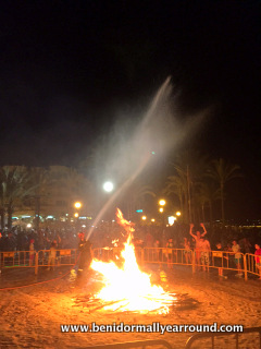 fireman dousing bonfire